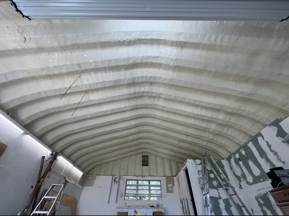 Spray polyurethane foam applied to the underside of a metal roof deck in Firestone